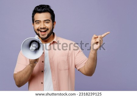 Young Indian man he wears pink shirt white t-shirt casual clothes hold in hand megaphone scream announces discounts sale Hurry up isolated on plain pastel light purple background. Lifestyle concept Royalty-Free Stock Photo #2318239125
