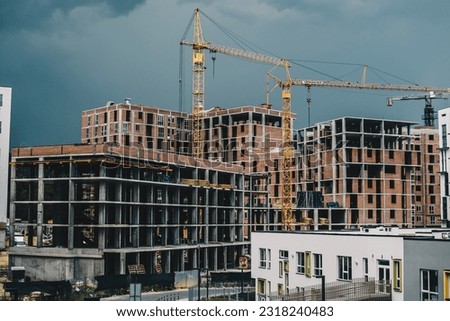 Construction site in Lviv, Ukraine. New residential houses being built. Cloudy stormy skies on the background. Royalty-Free Stock Photo #2318240483