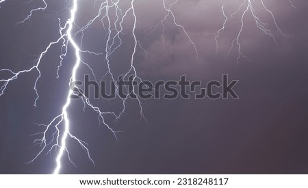 Lightning illuminating the overcast sky. A powerful lightning strike in the cloudy sky, on a dark stormy day over Madrid.