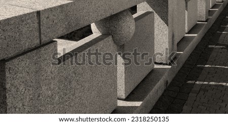 stone fence of granite blocks and balls