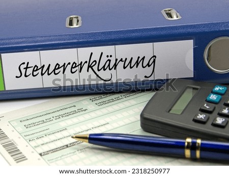 File folder labeled "Steuererklärung",  translation "Tax Return" and a form with the text "Income Tax Return, Church Tax,  Number, to the Tax Office"
