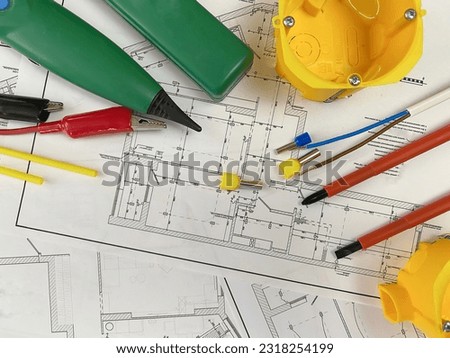 electrician tools on the background of the electrician plan. Place for text. Selective focus.