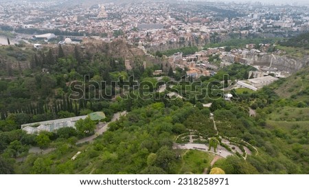 Sirirling in the Tbilian Botanical Garden from a height. View of the city of Tbilisi. Aero photo with drone. Traveling in Georgia, background with Tbilisi. Tbilisi in the spring. City landscape