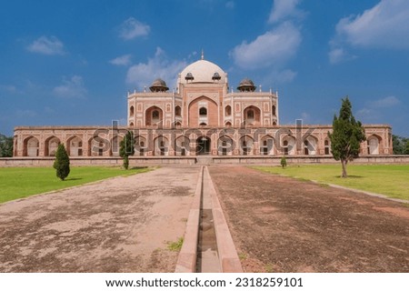 Large lawn in front Humayun's Tomb and the blue sky. Humayun's tomb is the tomb of the Mughal Emperor Humayun in Delhi, India. Royalty-Free Stock Photo #2318259101