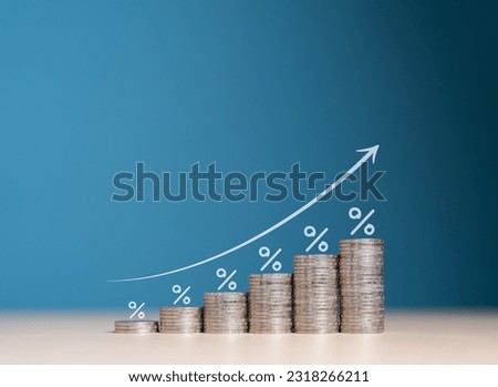 Financial interest rates hike, dividends and mortgage rates increase. Wooden blocks with percentage growth bar and arrow pointing up icon on stacked coins. Inflation, sale price and tax rise concept.