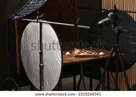 Professional equipment and composition with tasty meat medallions on wooden table in studio. Food photography