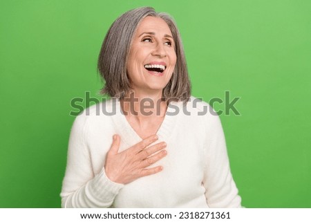 Portrait photo of pensioner woman grey bob hair hand heart laugh humor joking have fun positive look novelty isolated on green background Royalty-Free Stock Photo #2318271361