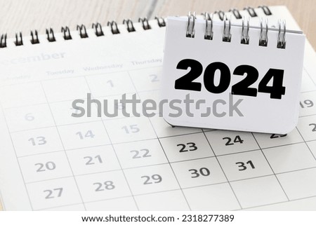 2024 year written in a notebook on a calendar.. 2024 plans with digital marketing concepts,business team and goals Royalty-Free Stock Photo #2318277389