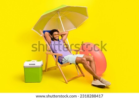 Full body length photo of relax weekend carefree student man lying sunbed parasol tropical country isolated on yellow color background