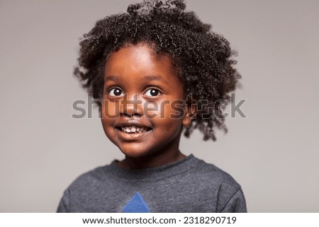 Captivating studio portrait of a young Ethiopian girl radiating pure joy, as she indulges in playful silliness and showcases her delightful expressions on a white seamless backdrop. Royalty-Free Stock Photo #2318290719