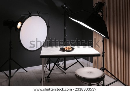 Composition with baked chicken, parsnip and strawberries on grey table in professional photo studio. Food photography Royalty-Free Stock Photo #2318303539