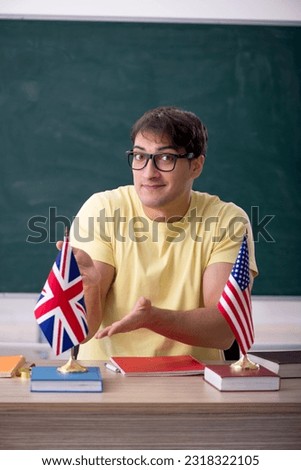 Young male English language teacher in the classroom