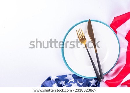 USA patriotic table setting with american flag, plate and decoration in national flag colors on white background. Independence Day. Happy Memorial Day dinner menu background top view copy space