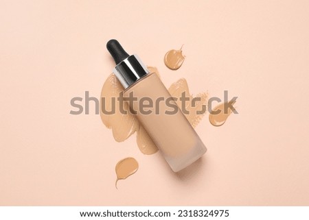 Liquid foundation and swatches on beige background, top view Royalty-Free Stock Photo #2318324975
