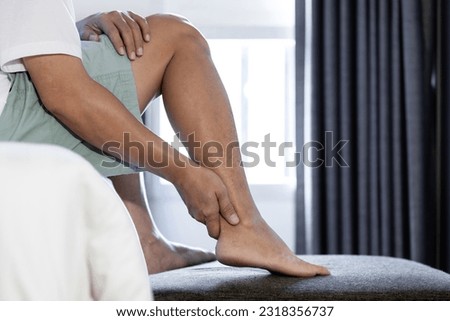 Problem of achilles tendon,middle aged man suffer from Achilles tendinitis,ligaments connecting calf muscles of leg to the heels injured,pain and stiffness in ankle bone or joints and sole of the foot Royalty-Free Stock Photo #2318356737