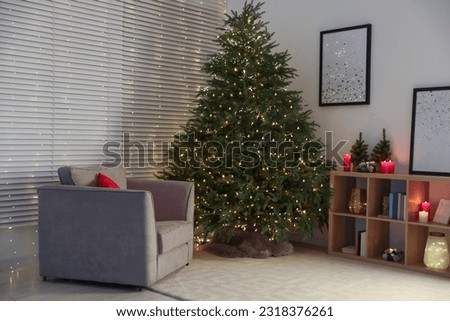 Beautiful Christmas tree with golden lights in living room