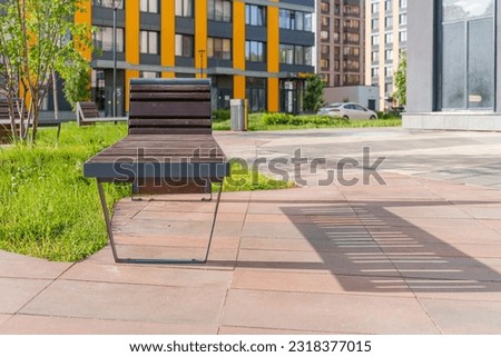Modern benches in the courtyard of condo complex. Comfortable urban environment. Residential complex is a comfort class. High quality photo