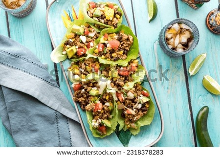Top down view of a platter of homemade turkey taco lettuce wraps.