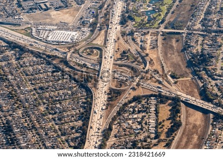 Aerial view of the I-5 Golden State Freeway and I-605 San Gabriel Freeway Interchange in Santa Fe Springs, California by the San Gabriel River. Royalty-Free Stock Photo #2318421669