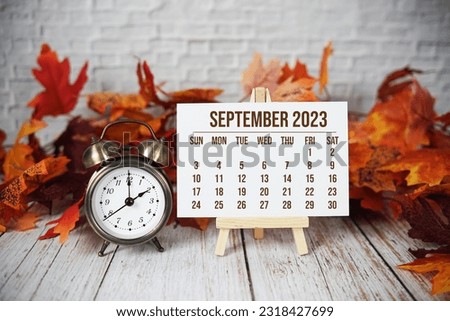 September 2023 monthly calendar with maple leaf on wooden background Royalty-Free Stock Photo #2318427699