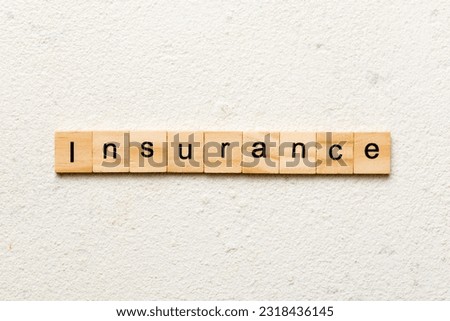 insurance word written on wood block. insurance text on table, concept.