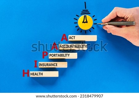 HIPAA symbol. Concept words HIPAA health insurance portability accountability act on wooden block. Beautiful blue background. Business HIPAA health insurance portability accountability act concept.