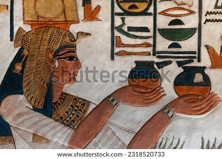 Nefertari offers jars of wine at her tomb in the Valley of queens . Luxor . Egypt . Royalty-Free Stock Photo #2318520733