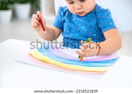 The child draws a rainbow. Selective focus. Baby.