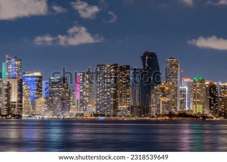 Miami Florida skyline view at Night with lights reflecting off the ocean