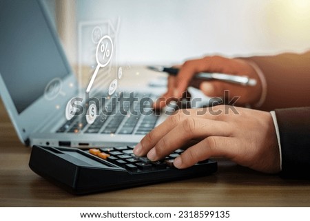 Human hand pressing calculator and virtual computer screen with percentage icon in magnifying glass. Concepts, finance, cost calculation, taxes, fees, service charges, etc.