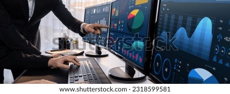 Analyst working on data analysis or BI dashboard on computer monitor. Business team analyzing financial data by Fintech in corporate office for business marketing and strategy planning. Trailblazing Royalty-Free Stock Photo #2318599581