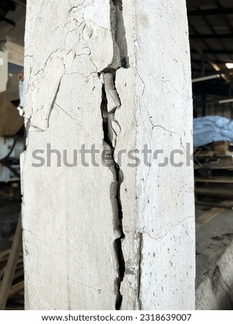 cracked concrete pillar of factory, cement separate construction site. The cement pillar was broken into a deep trench.