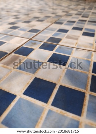 Old moldy bathroom tiles with geometric patterns made of ceramic arranged neatly, and made of luxurious, high-quality ceramic materials