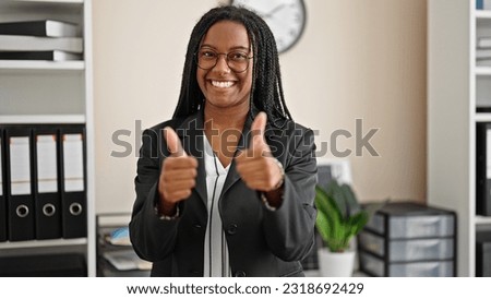 African american woman business worker smiling confident doing thumbs up gesture at office