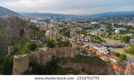 View of Tbilisi from the Sololaka hill. The fortress "Narikal". Medieval fortress in Georgia. Aero photo with drone. Traveling in Georgia, background with Tbilisi.Tbilisi in the spring.City landscape