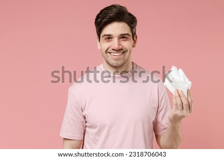 Sick ill ailing allergic man has red eyes runny nose suffer from allergy hold paper napkin isolated on pastel pink color wall background studio Healthy lifestyle disease treatment cold season concept Royalty-Free Stock Photo #2318706043