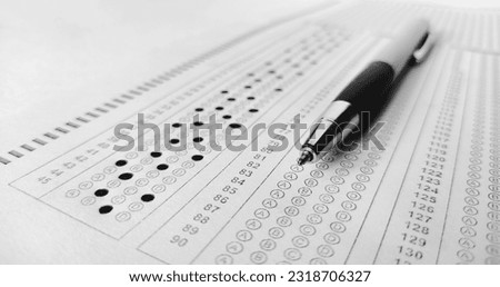 omr,exam, entrance exam, SAT, national testing agency,Pen on papers and forms .Man is filling OMR sheet handing with pen. Optical Mark Recognition, defocused image and contains noise for texture. Royalty-Free Stock Photo #2318706327