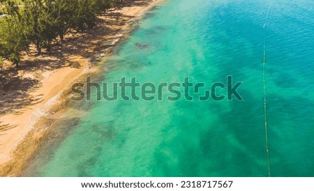 Seven Seas Beach in Fajardo, Puerto Rico. Turquoise waters of the swimming area marked by buoy on a sunny day. High angle view. High quality photo