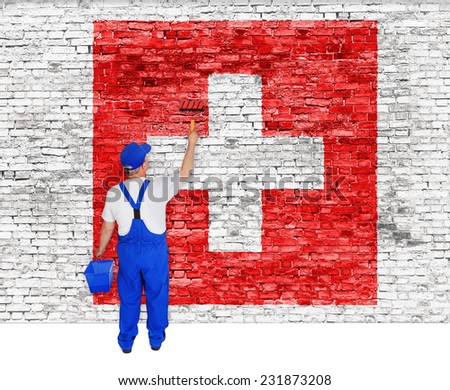 House painter covers brick wall with flag of Switzerland