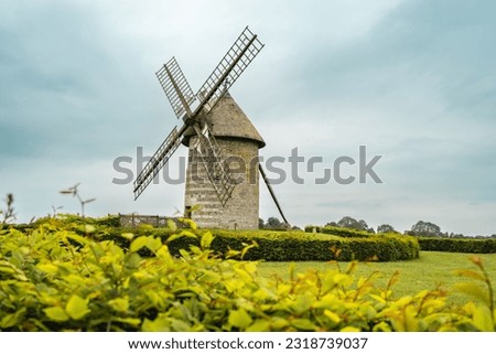 Moulin de pierre, old windmill in Hauville, France. Royalty-Free Stock Photo #2318739037