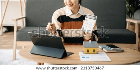 Asian woman working with House model real estate agent and customer discussing for contract to buy house, insurance or loan real estate consult concerning mortgage loan offer in home office.

 Royalty-Free Stock Photo #2318750467