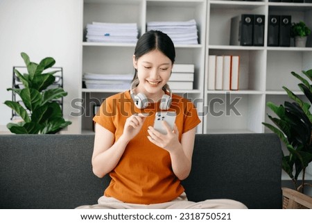 Asian young woman hands using smartphone and holding credit card sitting. Online Shopping payments concept.
