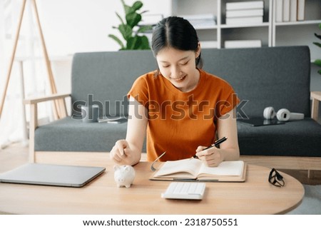 Asian Women are putting coins in a piggy bank for a business that grows for profit and saving money for the future. planning for retirement concept
 Royalty-Free Stock Photo #2318750551