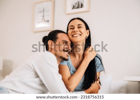Happy young couple of husband and wife spending time together at home Royalty-Free Stock Photo #2318756315