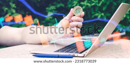 Laptop with chart and bitcoin in hands. Cryptocurrency gold coin, stock exchange graph