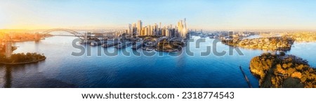 Sunrise panorama over Sydney city CBD landmarks on Harbour waterfront - wide aerial cityscape.