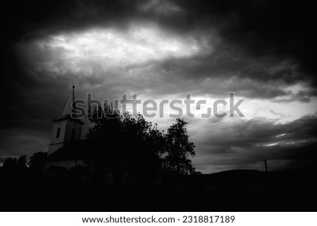 An old church in a remote countryside in Romania with drmatic, dark sky after sunset.