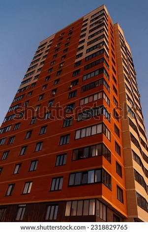 Red apartment building. urban modern architecture. urban landscape, vertical photography. skyscraper at sunset.