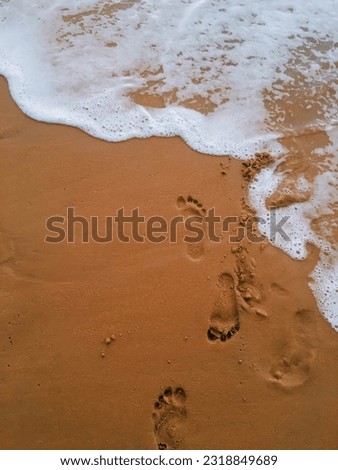 footprints left on the beach