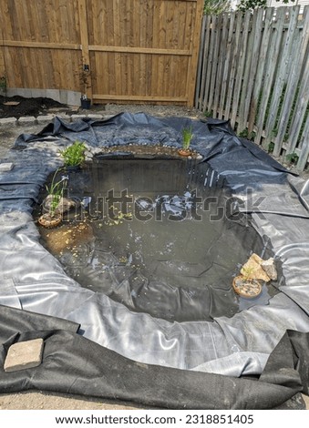 A backyard pond under construction